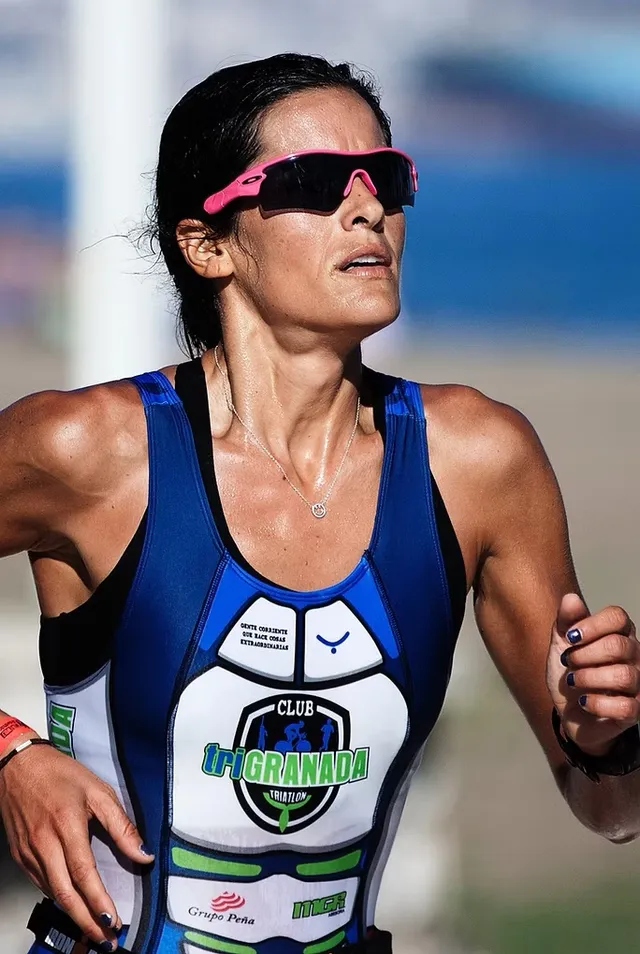 A triathlete running mid-race in the heat
